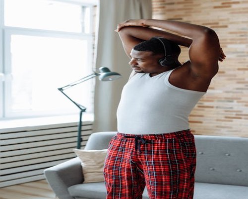 Man stretching casually at home